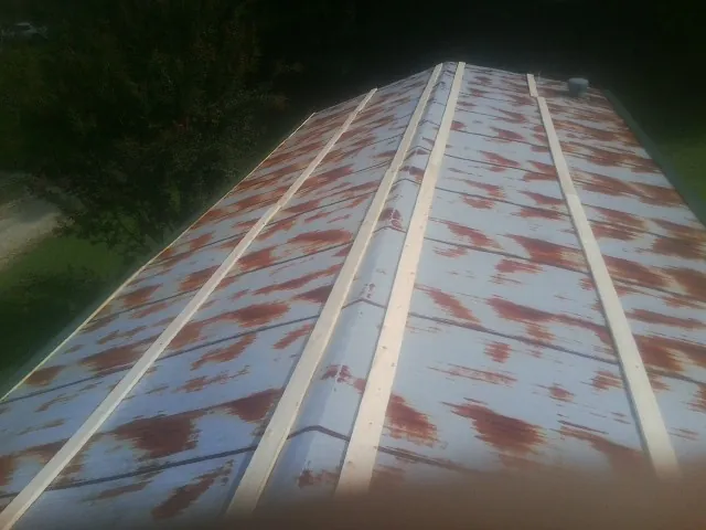 Rusted metal roof panels with new wood purlins before replacement — Storm Damage Roof Repair in Paupack by Roofing Brothers